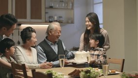 little asian girl presenting a cake to grandma and grandpa to celebrate their wedding anniversary - Powered by Shutterstock - Get 15% off with code: PIKWIZARD15