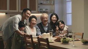 three generation asian family taking a group photo while celebrating grandma and grandpa's wedding anniversary - Powered by Shutterstock - Get 15% off with code: PIKWIZARD15