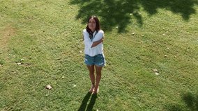 Video of beautiful young woman doing yoga and meditation in a park.