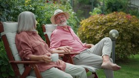 Senior couple sitting in garden, relaxing, having a conversation. - Powered by Shutterstock - Get 15% off with code: PIKWIZARD15