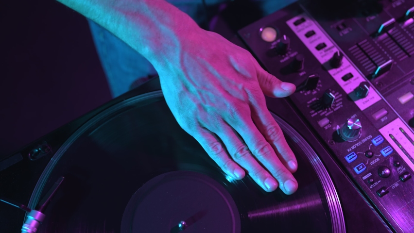 Hip hop dj scratches vinyl record on turn table player. Overhead video clip of disc jockey scratching records on turntables Royalty-Free Stock Footage #1096817953