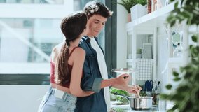 Video of lovely young couple cooking together in the kitchen at home. - Powered by Shutterstock - Get 15% off with code: PIKWIZARD15