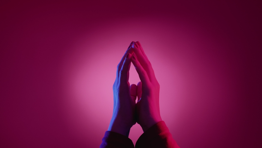 Wait answer. Hand expression. Visual gesture. Female palms holding together shaking fingers feeling impatience on neon light pink blue background. | Shutterstock HD Video #1096820677