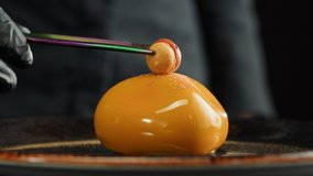 Mousse orange cake, creamy dessert close-up. Almond dacquoise, raspberry confit, crispy layer with caramelized hazelnuts and raspberry powder, mousse based on bitter chocolate. - Powered by Shutterstock - Get 15% off with code: PIKWIZARD15