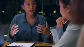 Millennial Asia people strategic meeting presentation brainstorming ideas about new paperwork project colleagues working together plan success strategy enjoy teamwork in small modern night office. - Powered by Shutterstock - Get 15% off with code: PIKWIZARD15