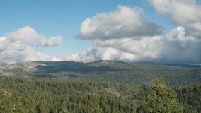 Clouds forming over mountain forest, 4k time lapse in california sierras, wide angle scenery of clouds and shadows moving over trees