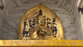 Gold Budha statue video 4K 60 FPS in japness on wall 