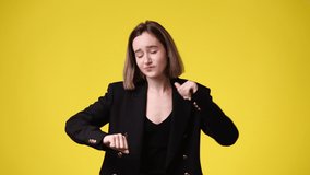 4k video of excited young woman dancing over yellow background,