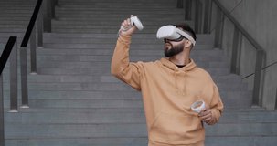 Experience VR. Young man with virtual reality headset near building