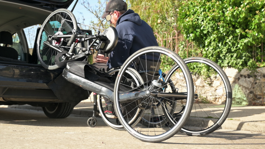 Athlete with disability Getting His Hand Cycle Ready To Ride. High quality 4k footage - Powered by Shutterstock - Get 15% off with code: PIKWIZARD15