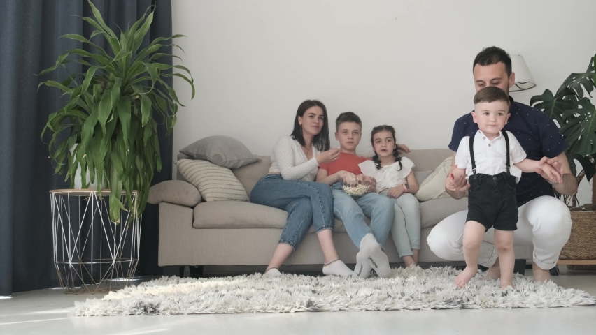 Father, mother, daughter and sons having fun at home, happy family together in living room