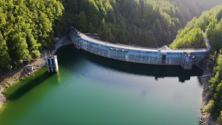Aerial view of the dam of Irabia, inside the forest of Irati, Spaina, the second extension of beech trees in Europe. Royalty-Free Stock Footage #1096862431