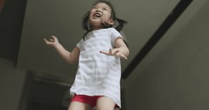 4K Video super slow motion asian kid jumping in trampoline. Video concept for freedom and children in Moment of  of joyfully.