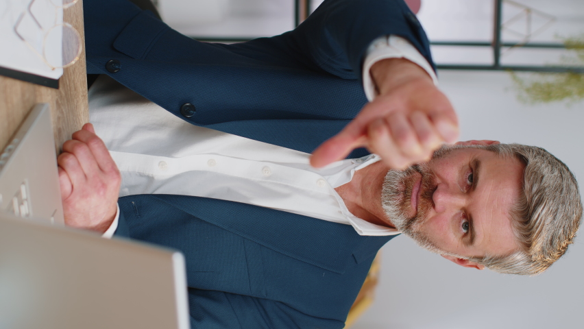 Dislike. Upset mature businessman working on laptop computer at home office thumbs down sign gesture, expressing discontent, disapproval, dissatisfied bad work. Displeased serious freelancer old man | Shutterstock HD Video #1096872677
