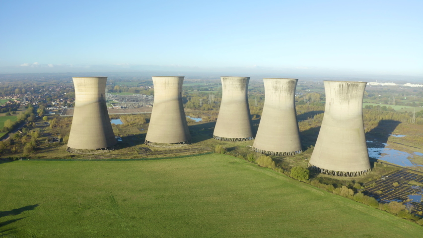 Nuclear power plant, aerial view. Drone flies over the cooling tower. Coal power plant. Aerial view to nuclear power plant. Apocalyptic landscape with an abandoned coal power plant. 