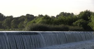 4K summer morning video of river dam waterfall in central Russia
