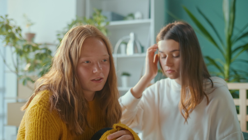 Help and Support. Red Haired Depressed Teenager Girl Talks to a Female Friend and Begin Crying, they Hug Sitting Together at Home. Teenage Psychological Trauma, Adolescence Concept. Mental Health | Shutterstock HD Video #1096883615