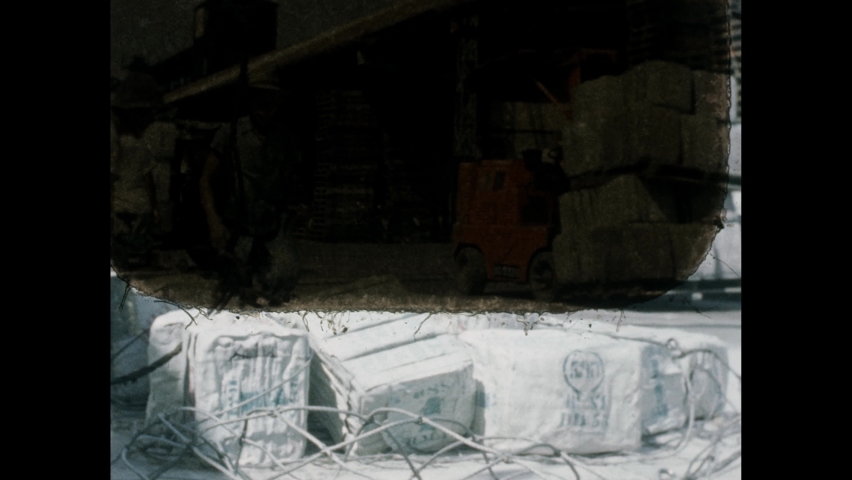 1960s: Warehouse. Men raise ship