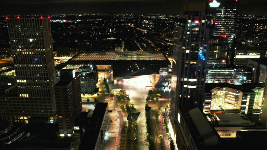 Aerials shots of the city center of Rotterdam at night. Erasmusbrug, Willemsbrug, The Hef, Central Train Station and passing boats over the river Meuse. 