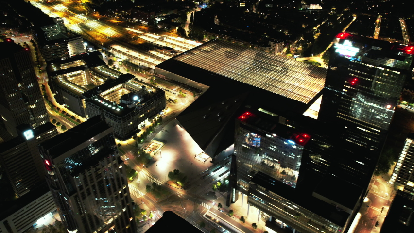Aerials shots of the city center of Rotterdam at night. Erasmusbrug, Willemsbrug, The Hef, Central Train Station and passing boats over the river Meuse. 