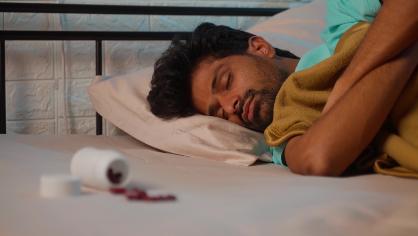 rack focus shot of young man in deep sleep with tablet