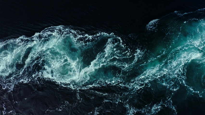 Abstract background. The waves of the sea water meet with underwater pointed rocks, forming whirlpools. Whirlpools in the area of the Norway Royalty-Free Stock Footage #1096893855