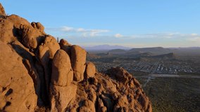 Cinematic aerial shot passing rocky peaks of desert mountains revealing Tucson Arizona, POV drone - Powered by Shutterstock - Get 15% off with code: PIKWIZARD15