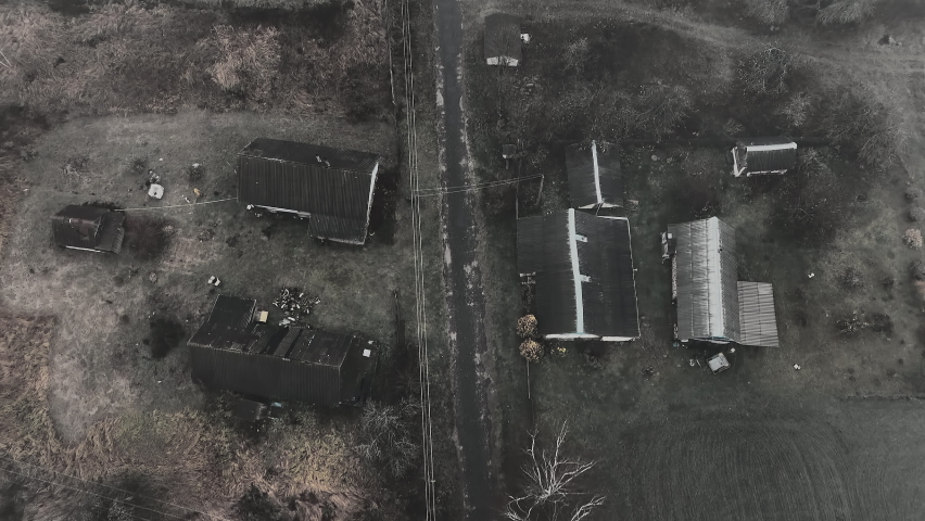 Darkness Village with houses in fog, aerial view. Fog over mystical country. Morning mist haze in rural. Country house in Foggy autumn. Morning scene in misty village. Rural landscape in mist haze. 
