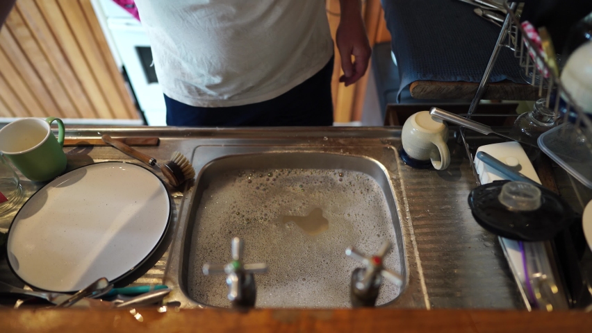 Washing dishes in a old dirty house in australia
 | Shutterstock HD Video #1096904545