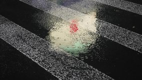 Closeup Rain drops Falling On puddle with lights reflection on city sidewalk. Rain drops on wet asphalt of city street, raindrops falling on zebra crossroad, Abstract 4k slow motion footage. - Powered by Shutterstock - Get 15% off with code: PIKWIZARD15