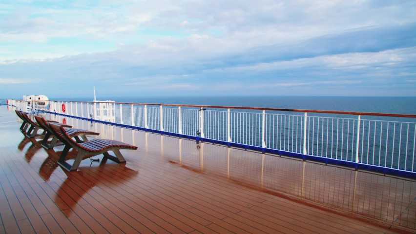 Sun loungers on the empty deck of the ship during a sea voyage. Absence of people due to pandemic or epidemic Royalty-Free Stock Footage #1096910275