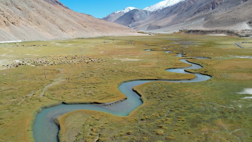  aerial video 4k of mountains with river and green valley in Himalayas with blue sky in Nubra valley, Jammu and Kashmir, India. 