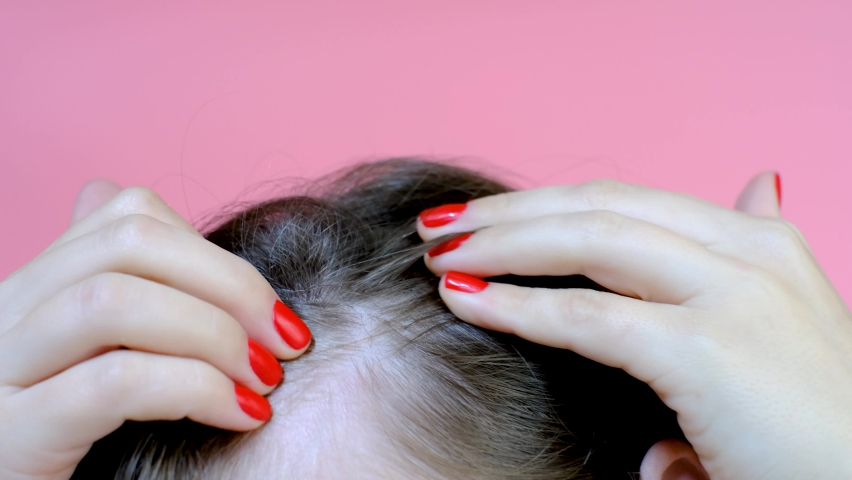 Girl touching her hair close-up on pink background , hair loss concept. Royalty-Free Stock Footage #1096912793