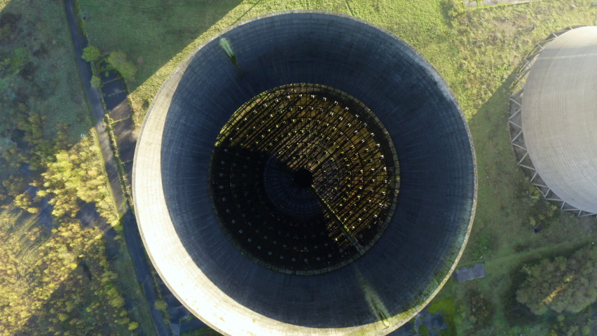 Nuclear power plant, aerial view. Drone flies over the cooling tower. Coal power plant. Aerial view to nuclear power plant. Apocalyptic landscape with an abandoned coal power plant. 