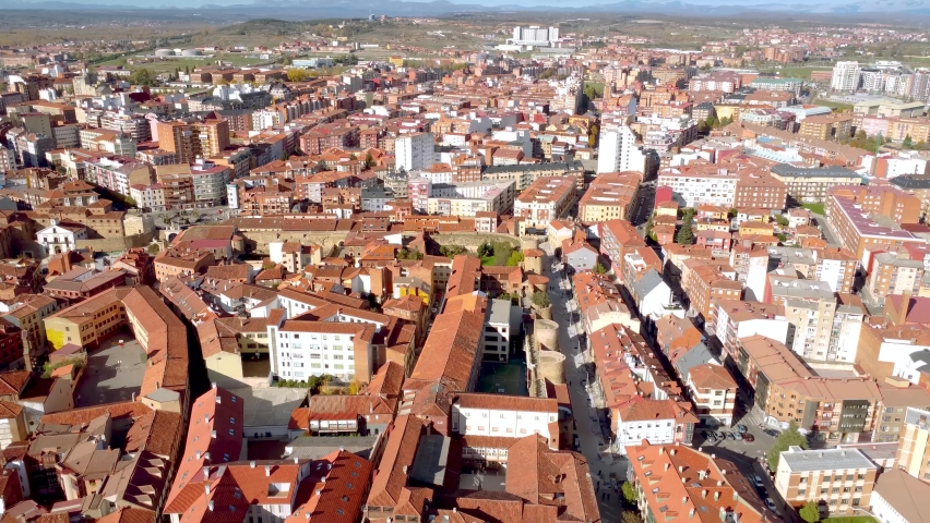 Aerial point ow view of Leon city. Situated in northwest of Spain is an old historic city and an important travel destination. Drone backward passing above the Cathedral of Leon and tilt up