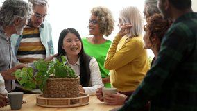 multicultural family gathered in the kitchen at home, at the adult party, birthday. focus on senior woman with gray hair - - Powered by Shutterstock - Get 15% off with code: PIKWIZARD15