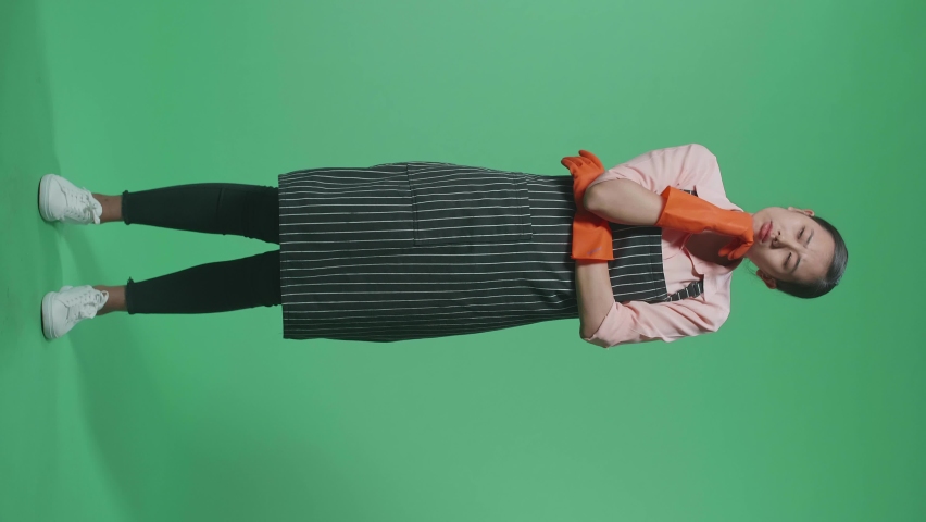Full Body Of Sad Asian Female Housekeeper With An Apron Thinking About Something And Looking Around While Standing In The Green Screen Studio
 | Shutterstock HD Video #1096926673