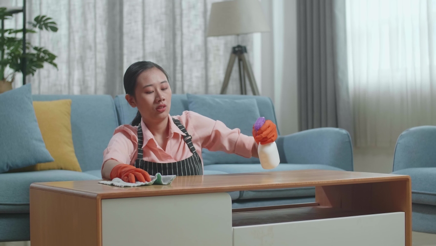 Tired Asian Female Housekeeper With An Apron Cleaning The Table By The Spray At Home
 | Shutterstock HD Video #1096926737