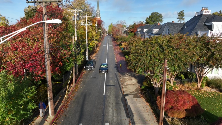 Rising aerial of historic American town in autumn. Colorful autumn fall foliage and tree leaves.