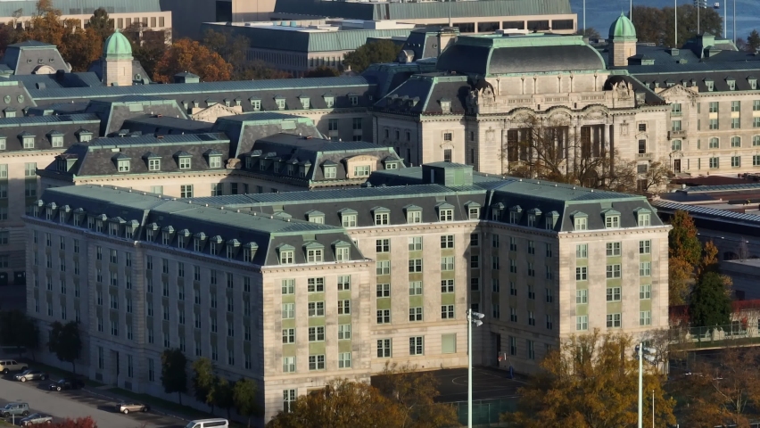 United States Naval Academy building. US Navy and Marine Corp training grounds and campus yard. Rising aerial with Annapolis Maryland in distance.
