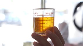Side view of a measuring cup measuring syrup to make coffee. - Powered by Shutterstock - Get 15% off with code: PIKWIZARD15