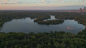 4K Aerial View Orbit Lake Of The Isles Revealing Minneapolis Skyline At Sunset