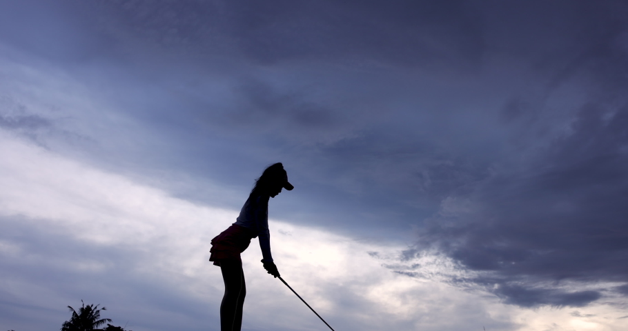 Silhouette Young Asian female golfer Swing Drive Golf, wide angle shot slow motion 4k video
