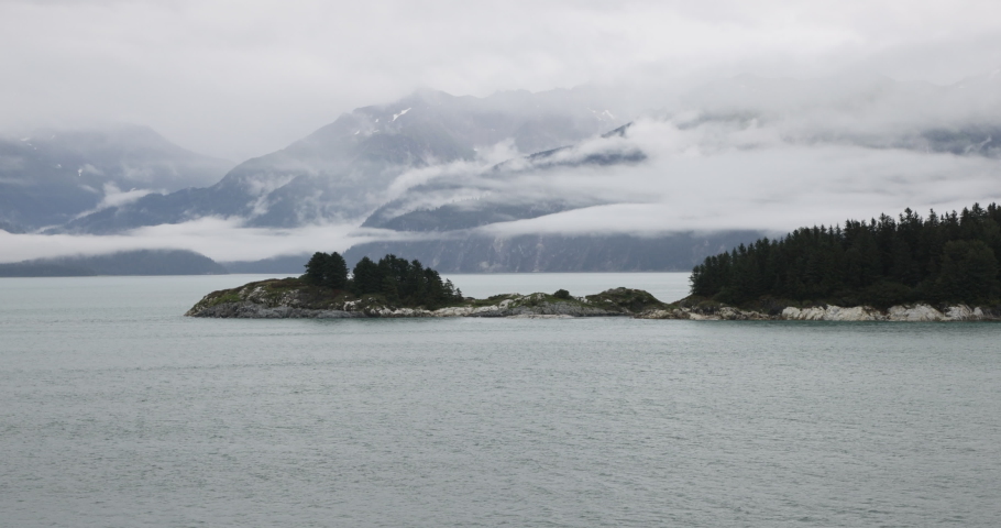 Inside Passage Alaska island mountain forest cruise. Coastal route for ships and boats. Network of natural island channels through the Pacific Northwest coast of North American Fjord of Alaska.
