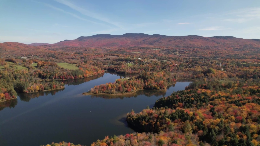 new england fall leaf color over vermont lake in autumn