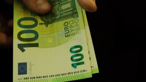 a man counts bills one hundred euros, close-up, slowed down