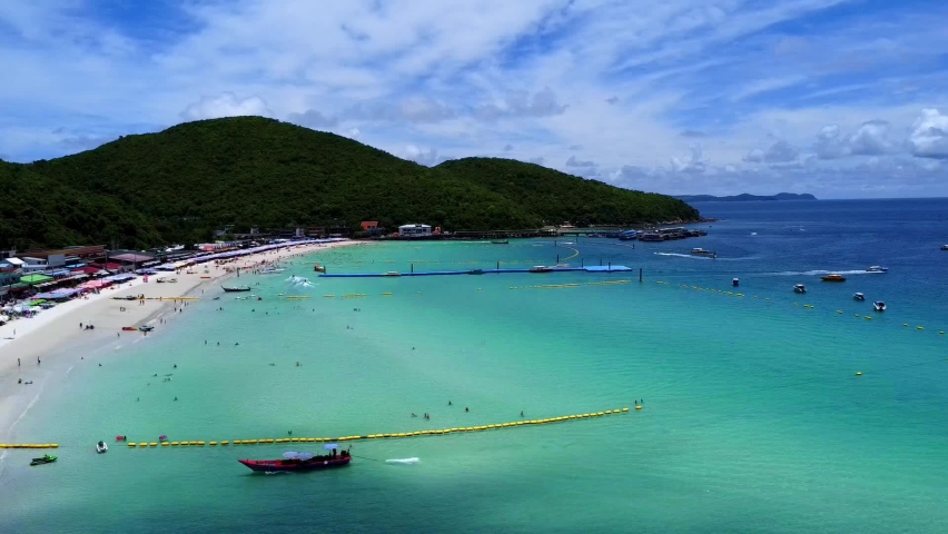 Ko Lan is a small Thai island off the coast of Pattaya, in the Gulf of Thailand. It’s known for its beaches, set against a backdrop of wooded hills. Ko Lan is also known as Ko Larn and Coral Island. Royalty-Free Stock Footage #1096968633