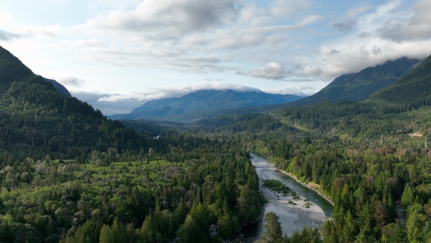 Wide aerial view of Baring, Washington surrounded by the Cascade Mountains and dense forests.