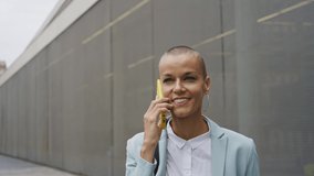 Beautiful modern business woman with shaved head at work during a business journey	