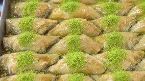 Types of Turkish baklava in trays, burma kadayif, sobiyet,sutlu nuriye, chocolate baklava, Turkish traditional sherbet desserts.4K Video shooting.
